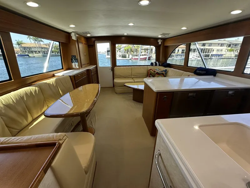 Slide: The Image of Luxurious interior of a 2006 Cabo 48 Convertible yacht with elegant seating and large windows. - 10
