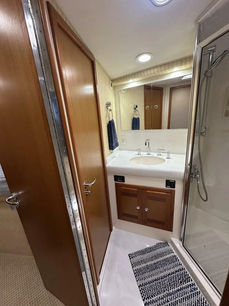 Slide: The Image of Bathroom interior of 2006 Cabo 48 Convertible yacht with sink and shower. - 13