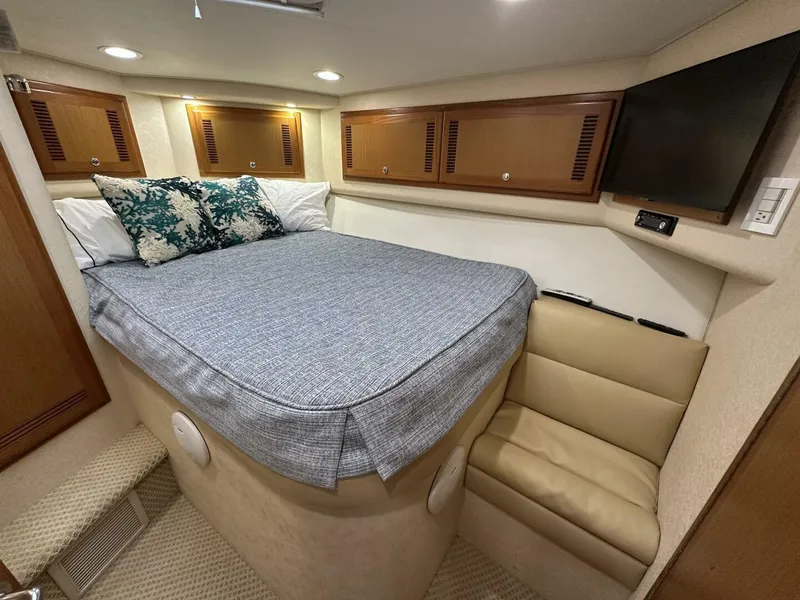Slide: The Image of Luxurious cabin interior of 2006 Cabo 48 Convertible yacht with bed and TV. - 15