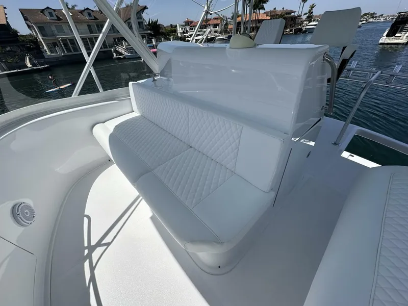 Slide: The Image of Luxurious seating on a 2006 Cabo 48 Convertible yacht, docked near waterfront homes. - 24