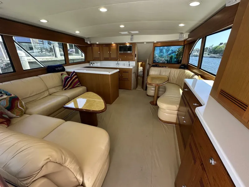 Slide: The Image of Luxurious interior of 2006 Cabo 48 Convertible yacht with leather seating and wooden cabinetry. - 3