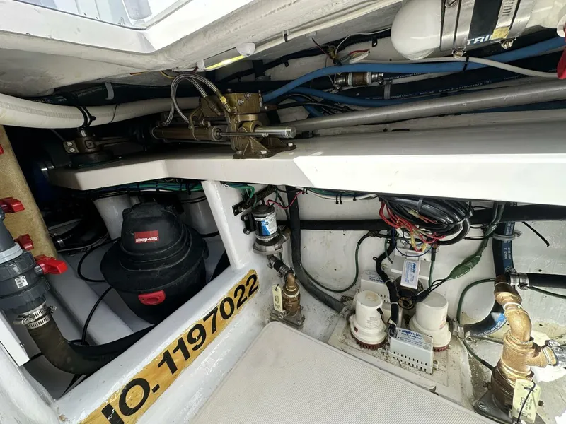 Slide: The Image of Engine room of 2006 Cabo 48 Convertible boat with mechanical components and wiring. - 31