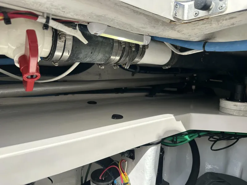 Slide: The Image of Engine compartment of a 2006 Cabo 48 Convertible boat, showing pipes and wiring. - 32
