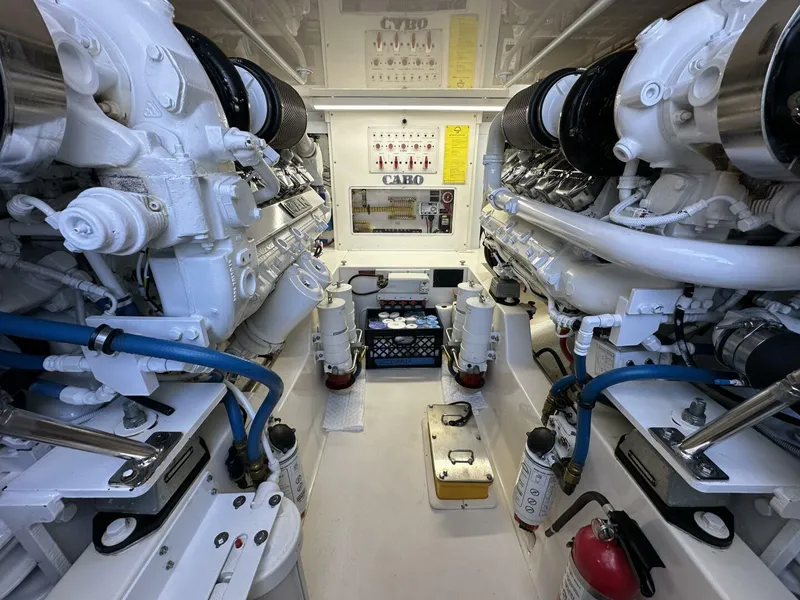Slide: The Image of Engine room of a 2006 Cabo 48 Convertible yacht, showcasing dual engines and mechanical components. - 38