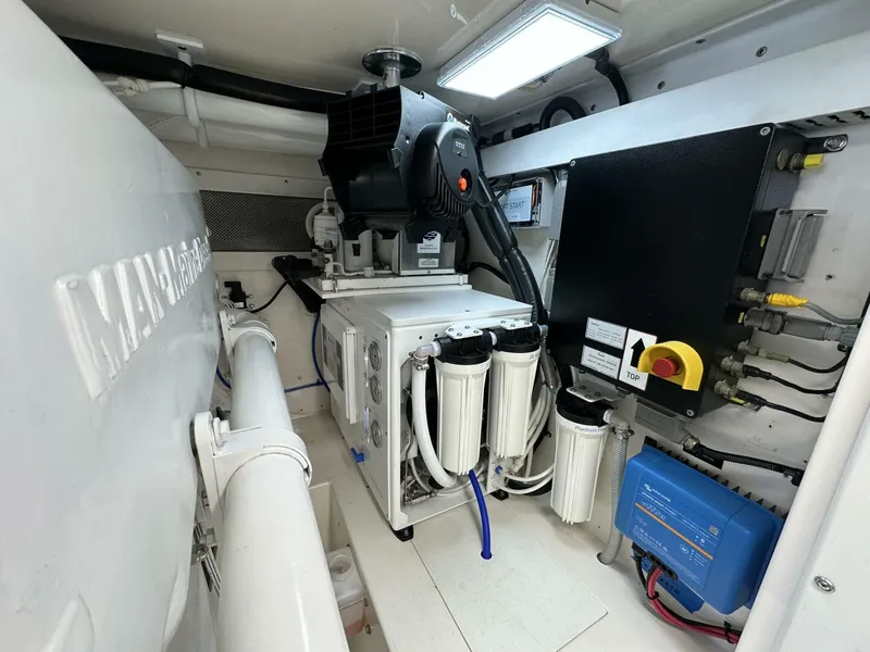 Slide: The Image of Engine room of 2006 Cabo 48 Convertible yacht with filtration system and electrical components. - 39
