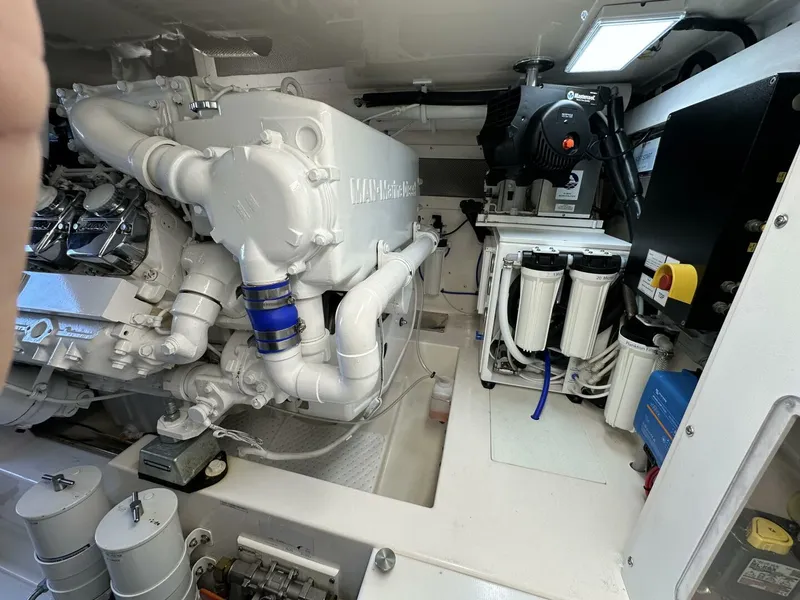 Slide: The Image of Engine room of 2006 Cabo 48 Convertible yacht, showcasing mechanical components and systems. - 41