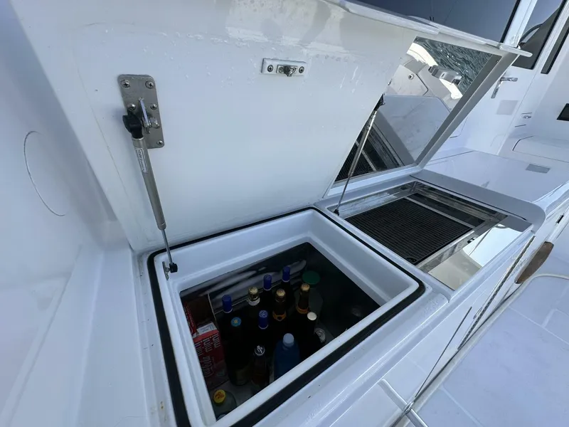 Slide: The Image of Built-in cooler with beverages on a 2006 Cabo 48 Convertible yacht deck. - 46