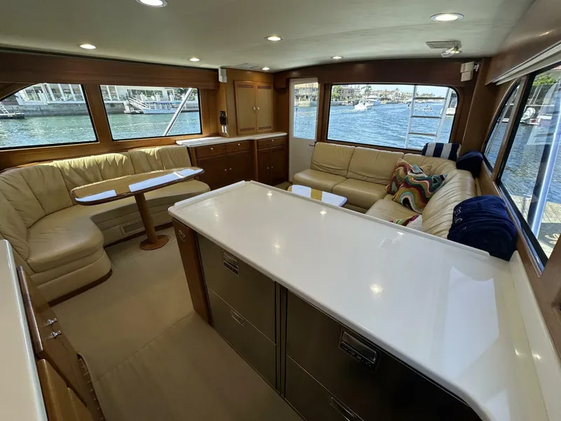 Slide: The Image of Luxurious interior of 2006 Cabo 48 Convertible yacht with plush seating and waterfront views. - 8