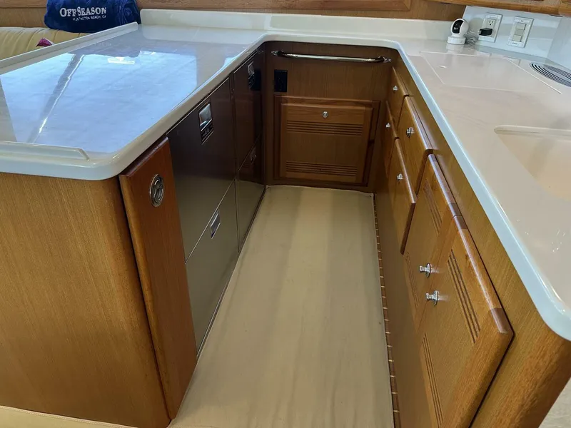 Slide: The Image of 2006 Cabo 48 Convertible yacht kitchen with wooden cabinetry and modern appliances. - 9