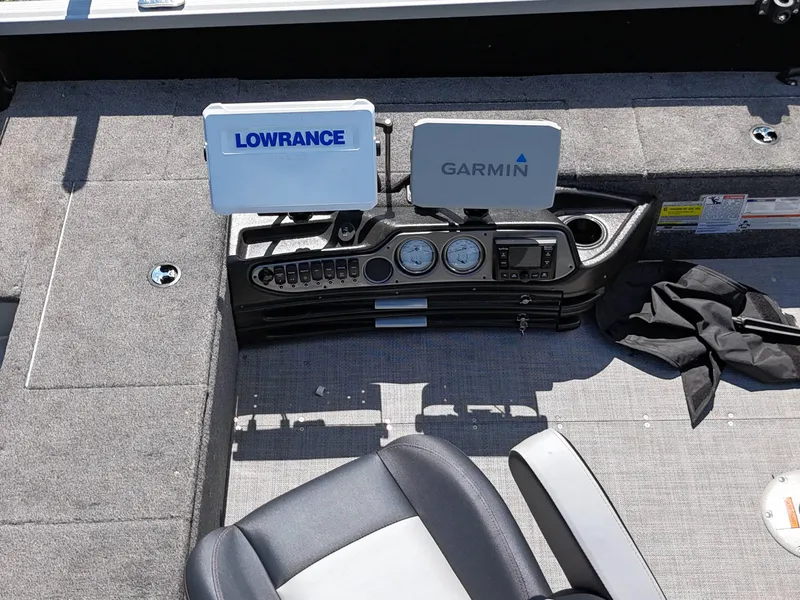 Slide: The Image of 2023 Alumacraft Competitor 185 Tiller dashboard with Lowrance and Garmin displays. - 13