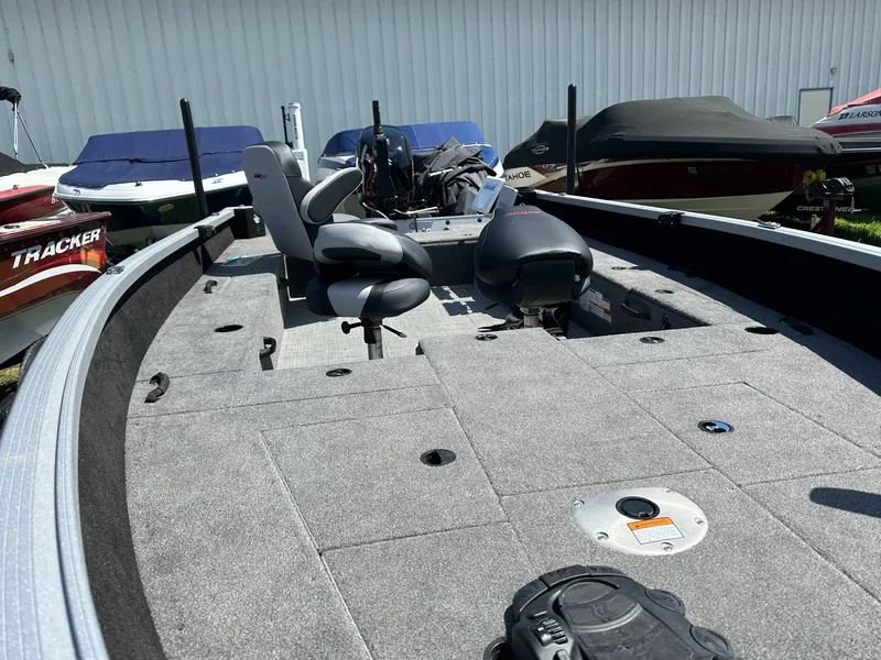 Slide: The Image of 2023 Alumacraft Competitor 185 Tiller boat interior with seating and storage compartments. - 16