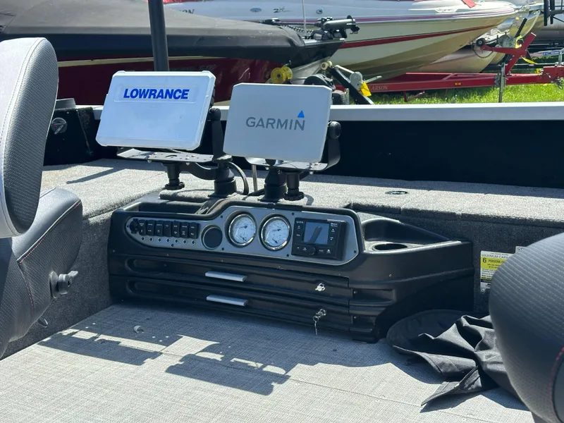 Slide: The Image of 2023 Alumacraft Competitor 185 Tiller dashboard with Lowrance and Garmin displays. - 19