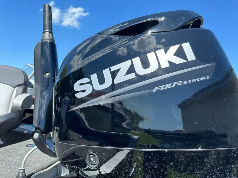 Slide: The Image of 2023 Alumacraft Competitor 185 Tiller with Suzuki Four Stroke engine under blue sky. - 22