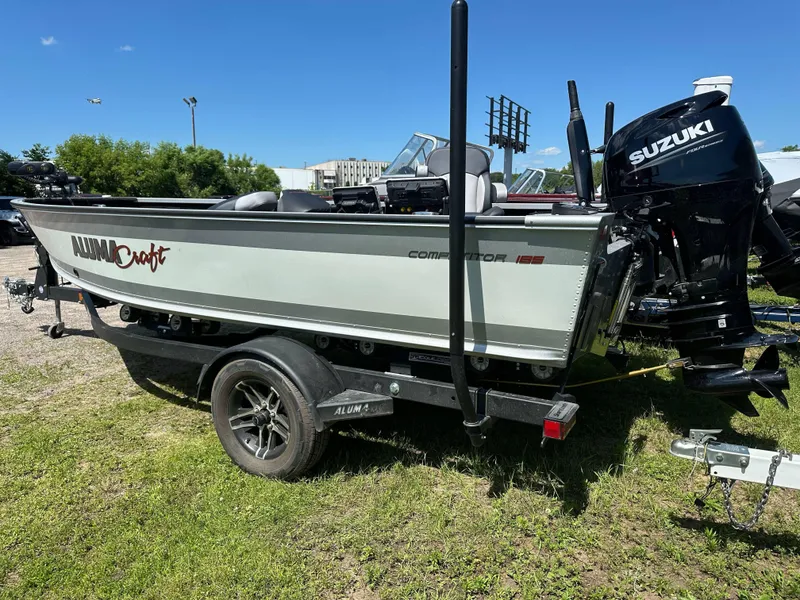 Slide: The Image of 2023 Alumacraft Competitor 185 Tiller boat with Suzuki engine on trailer. - 31