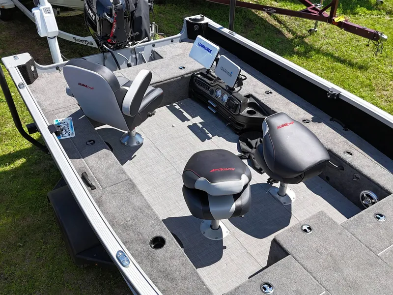 Slide: The Image of 2023 Alumacraft Competitor 185 Tiller boat interior with seating and navigation equipment. - 6