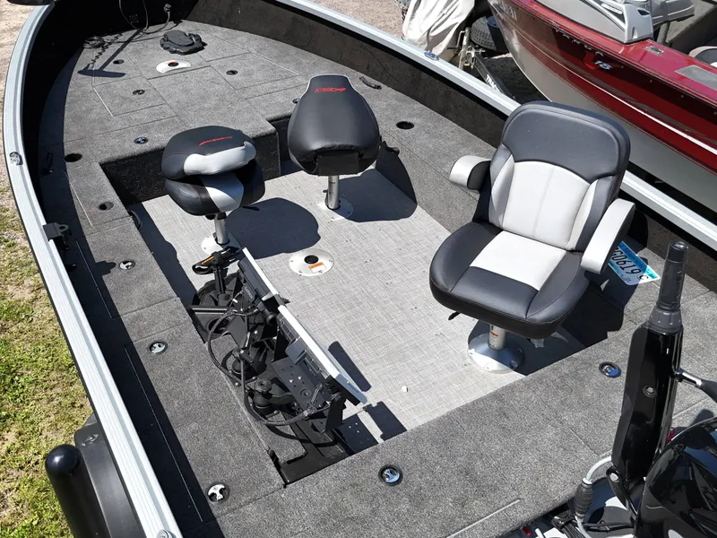 Slide: The Image of 2023 Alumacraft Competitor 185 Tiller boat interior with seating and fishing equipment. - 7