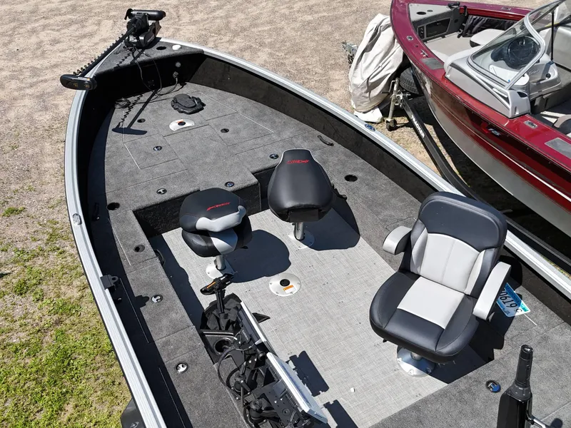Slide: The Image of 2023 Alumacraft Competitor 185 Tiller boat interior with seating and fishing equipment. - 8