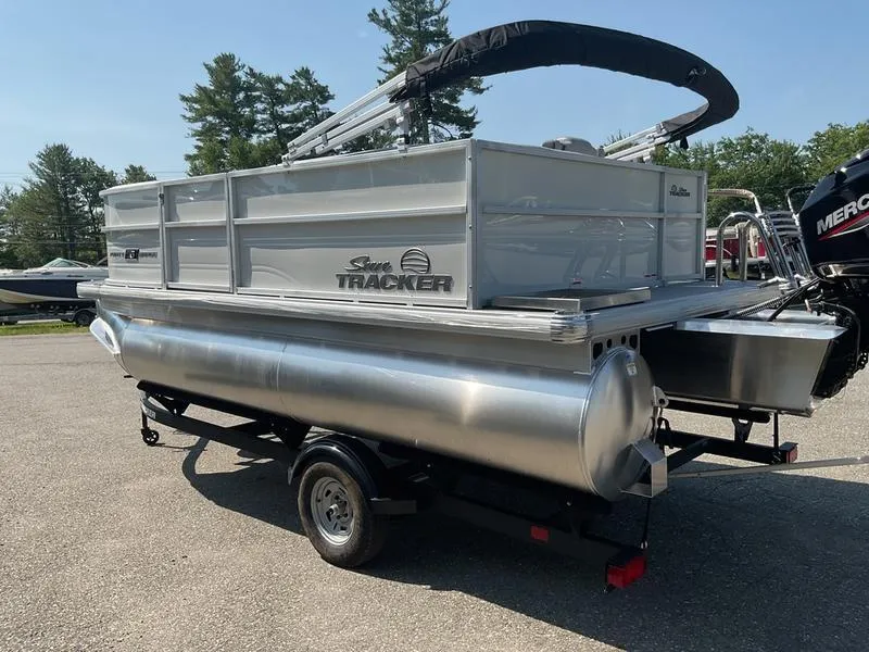 Slide: The Image of 2026 Sun Tracker PB 16 DLX pontoon boat on trailer, outdoor setting. - 10