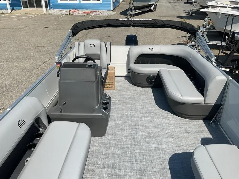 Slide: The Image of 2026 Sun Tracker PB 16 DLX pontoon boat interior with gray seating and steering console. - 11