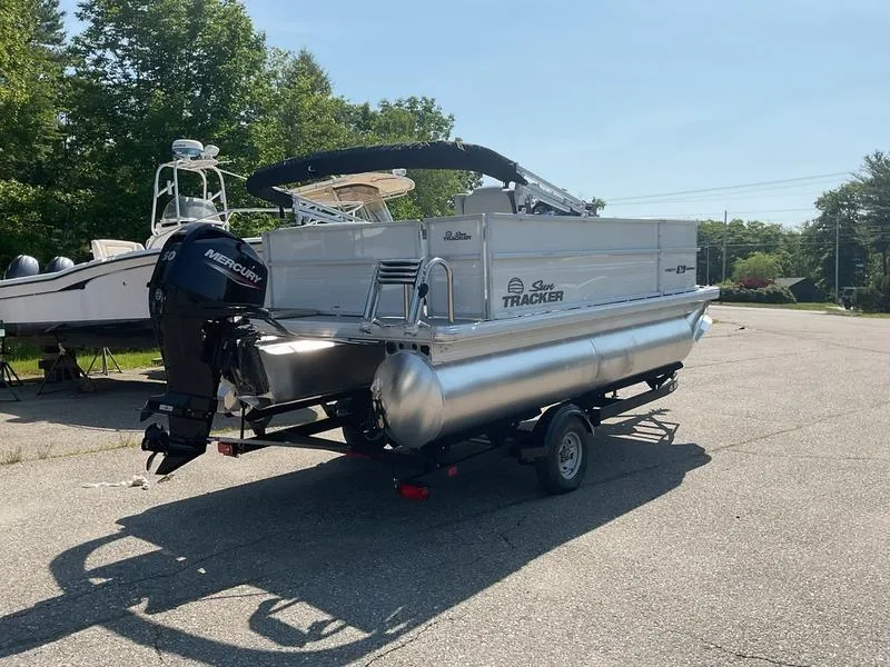 Slide: The Image of 2026 Sun Tracker PB 16 DLX pontoon boat on trailer, parked outdoors. - 5