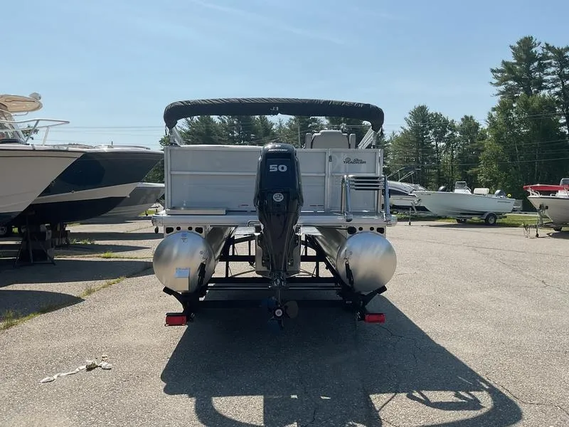 Slide: The Image of 2026 Sun Tracker PB 16 DLX pontoon boat with 50 HP motor in a marina. - 7