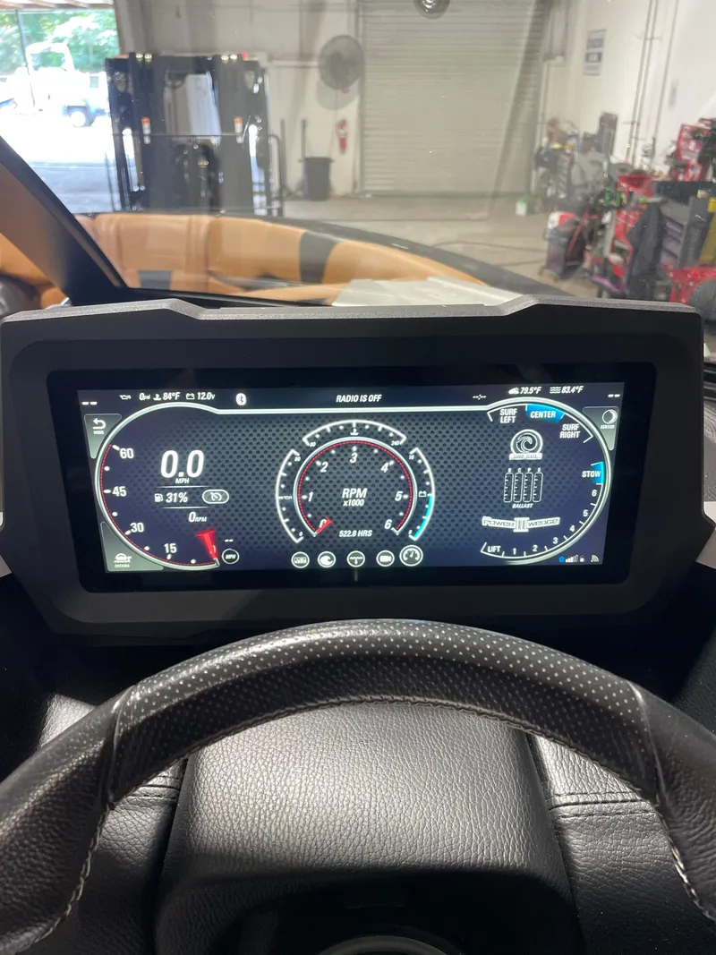 Slide: The Image of 2022 Malibu Wakesetter 23 LSV dashboard display showing RPM and speedometer. - 2