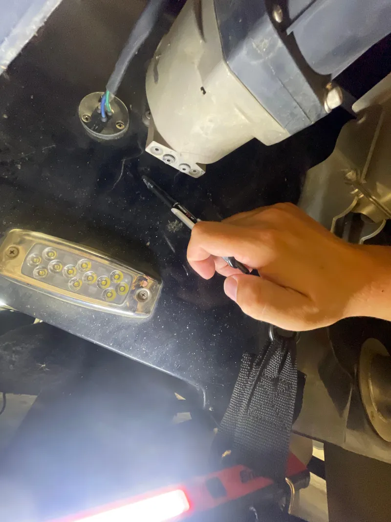 Slide: The Image of Hand inspecting Malibu Wakesetter 23 LSV 2022 boat components with LED light. - 3