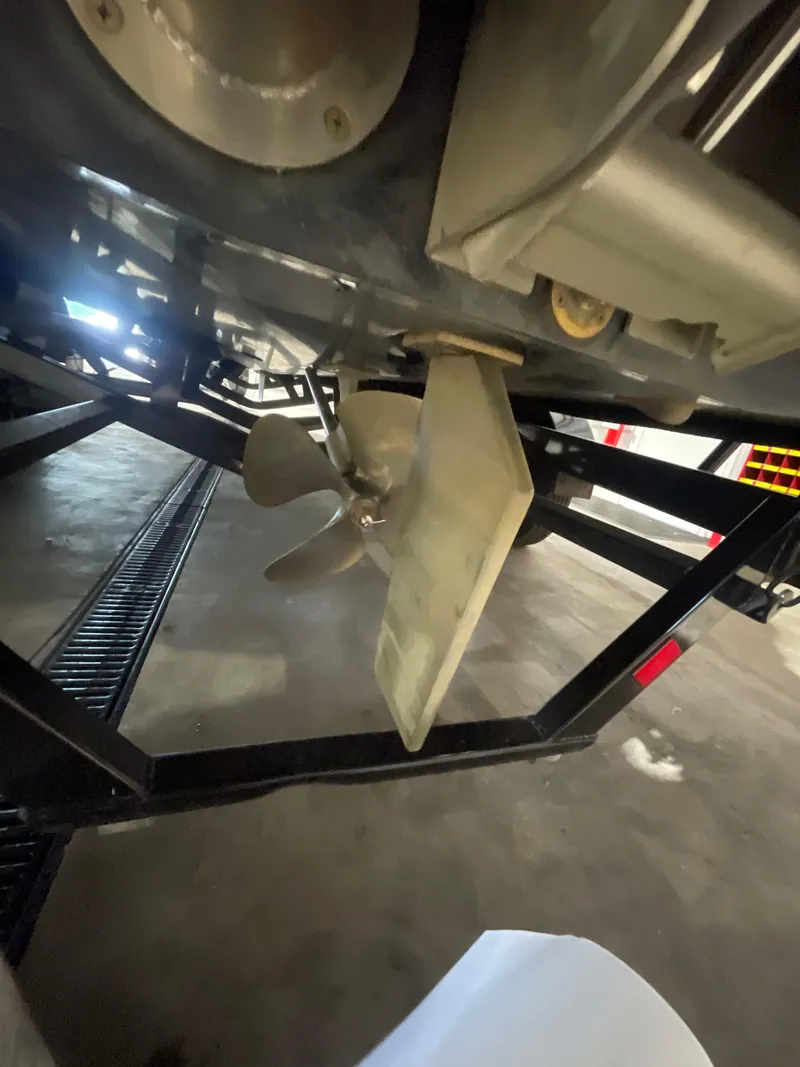 Slide: The Image of 2022 Malibu Wakesetter 23 LSV propeller and rudder detail in a garage setting. - 5