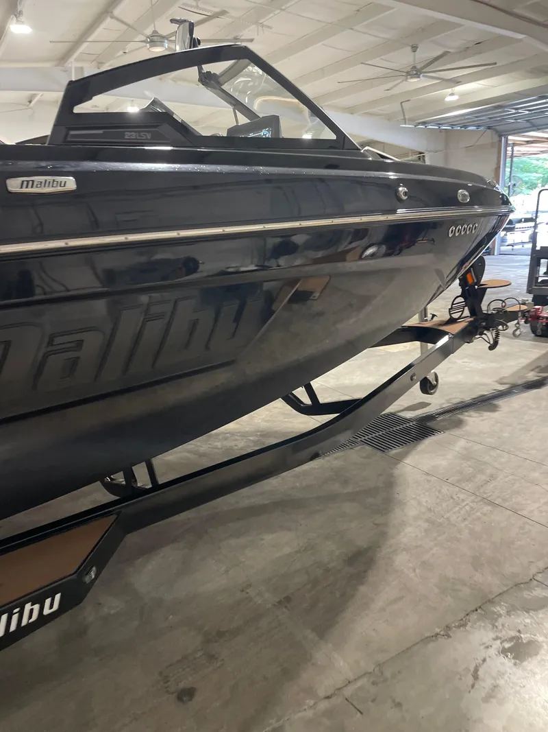 Slide: The Image of 2022 Malibu Wakesetter 23 LSV boat in a garage, side view. - 8
