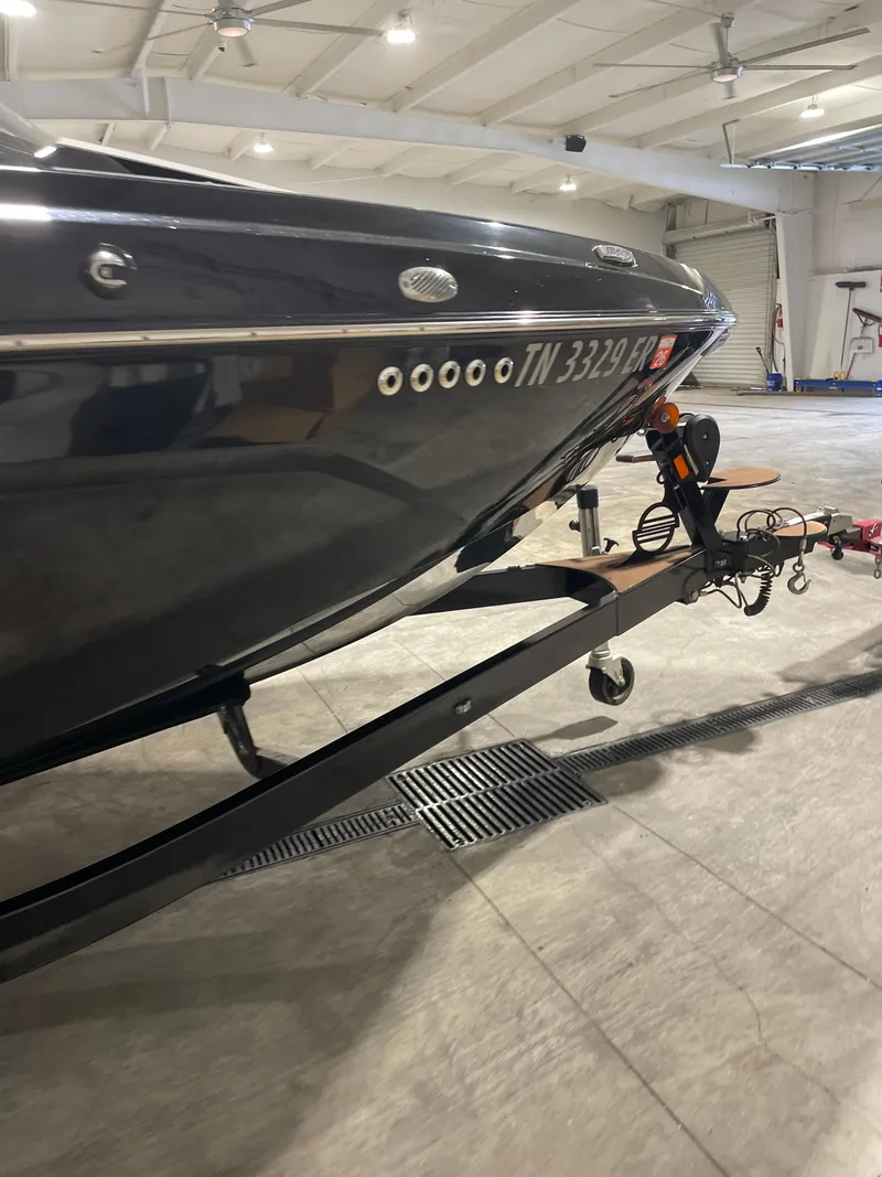 Slide: The Image of 2022 Malibu Wakesetter 23 LSV boat on trailer in indoor storage. - 9