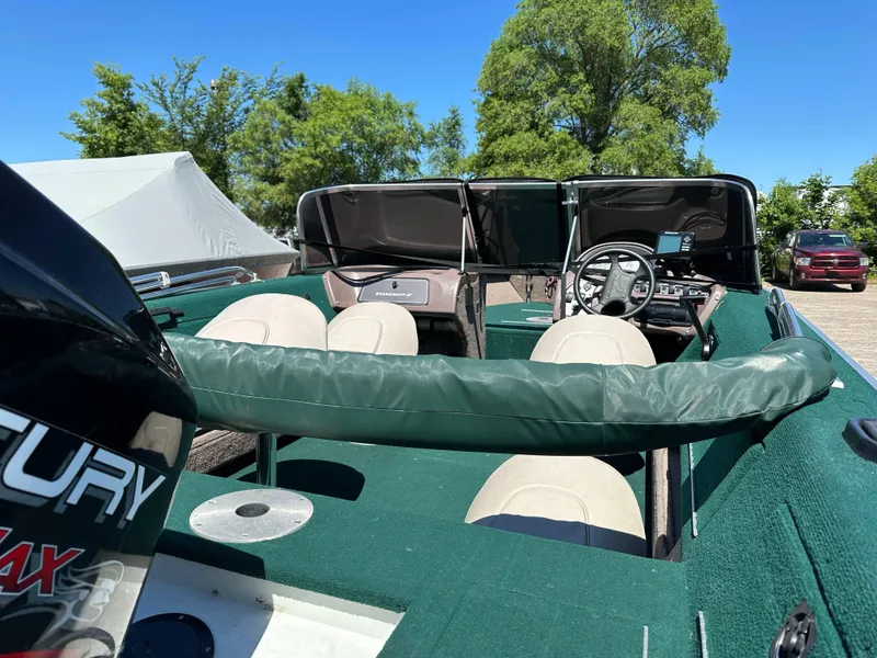 Slide: The Image of 2000 Starcraft Superfisherman 176 DC boat interior with green upholstery and Mercury engine. - 14
