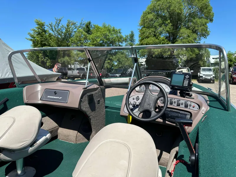 Slide: The Image of 2000 Starcraft Superfisherman 176 DC boat interior with steering wheel and dashboard controls. - 18