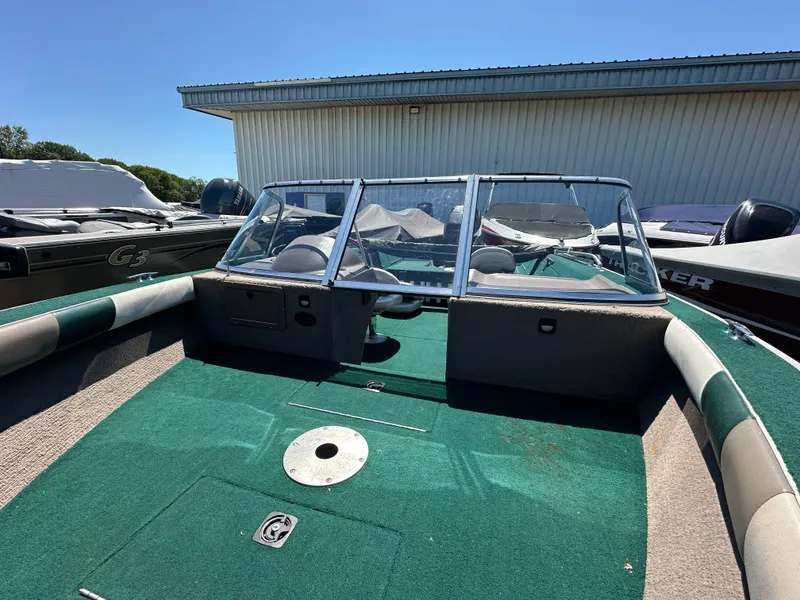 Slide: The Image of 2000 Starcraft Superfisherman 176 DC boat with green interior, parked outdoors. - 19