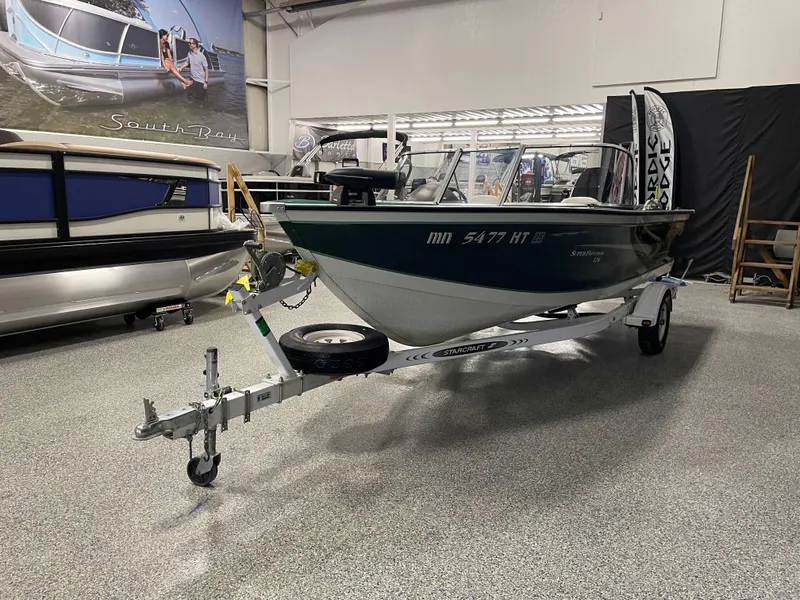 Slide: The Image of 2000 Starcraft Superfisherman 176 DC boat interior with green carpet and PowerDrive motor. - 22