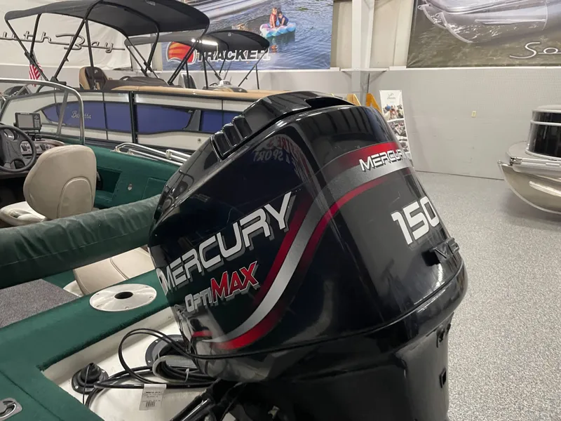 Slide: The Image of 2000 Starcraft Superfisherman 176 DC boat interior with green carpet and fishing equipment. - 26