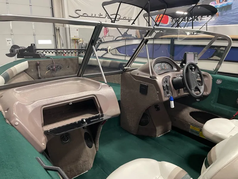 Slide: The Image of 2000 Starcraft Superfisherman 176 DC dashboard with steering wheel and fish finder. - 29
