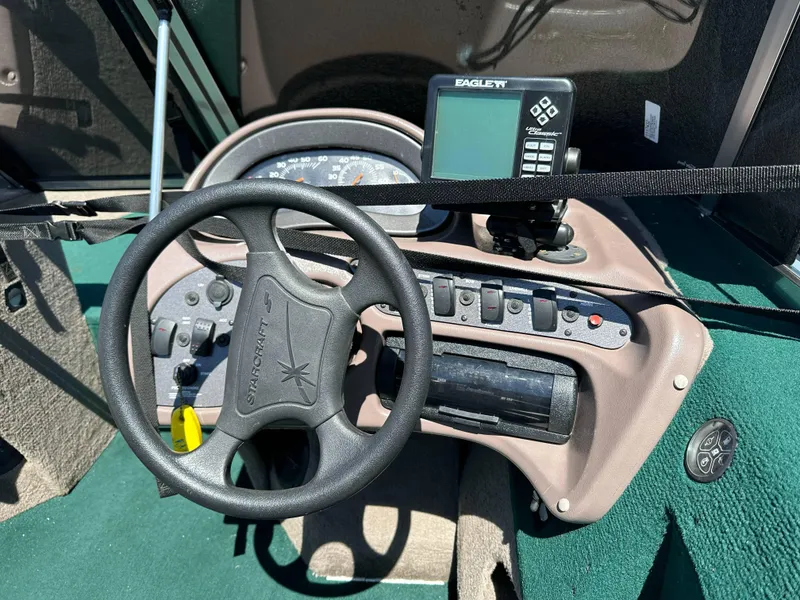 Slide: The Image of 2000 Starcraft Superfisherman 176 DC boat with Mercury 150 outboard motor, parked outdoors. - 4