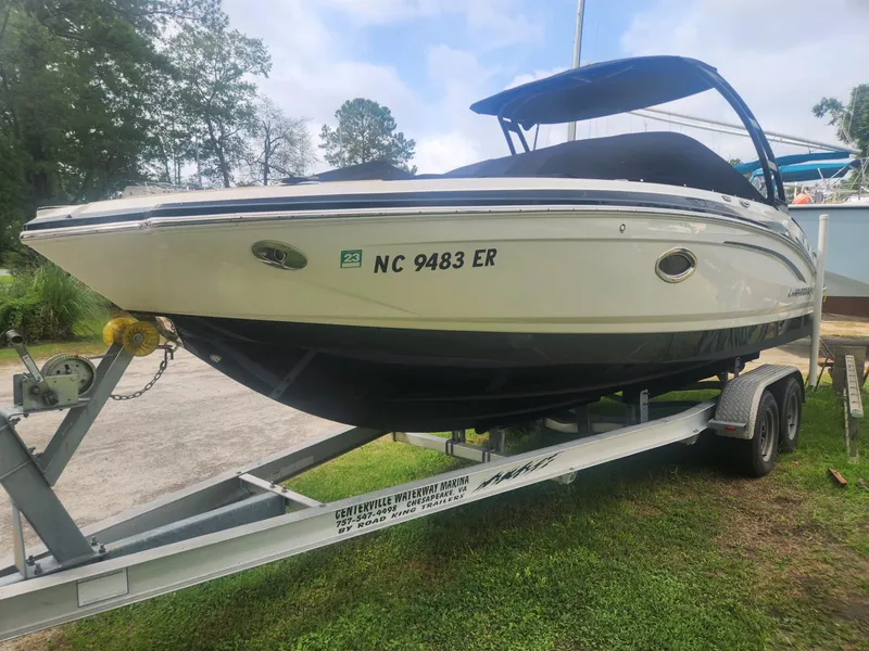 The Image of 2016 Chaparral 246 SSi boat on trailer, parked outdoors, with blue canopy. - 0