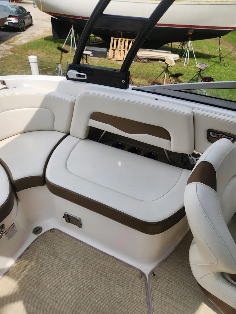 Slide: The Image of 2016 Chaparral 246 SSi boat interior with white and brown seating. - 21