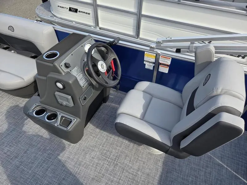 Slide: The Image of 2026 Sun Tracker PB 16 DLX boat interior with steering console and seating. - 10