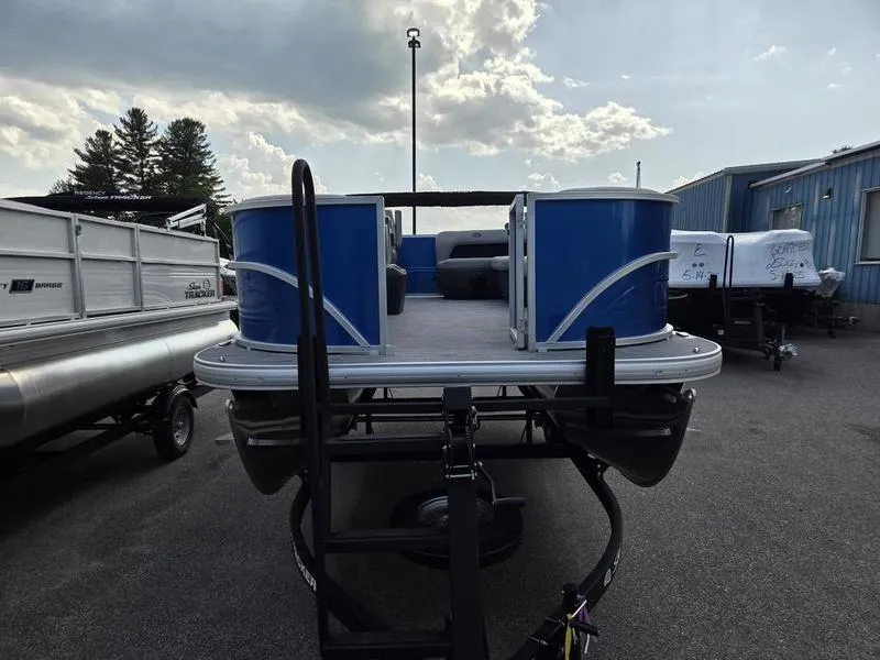 Slide: The Image of 2026 Sun Tracker PB 16 DLX pontoon boat on trailer, parked outdoors. - 6