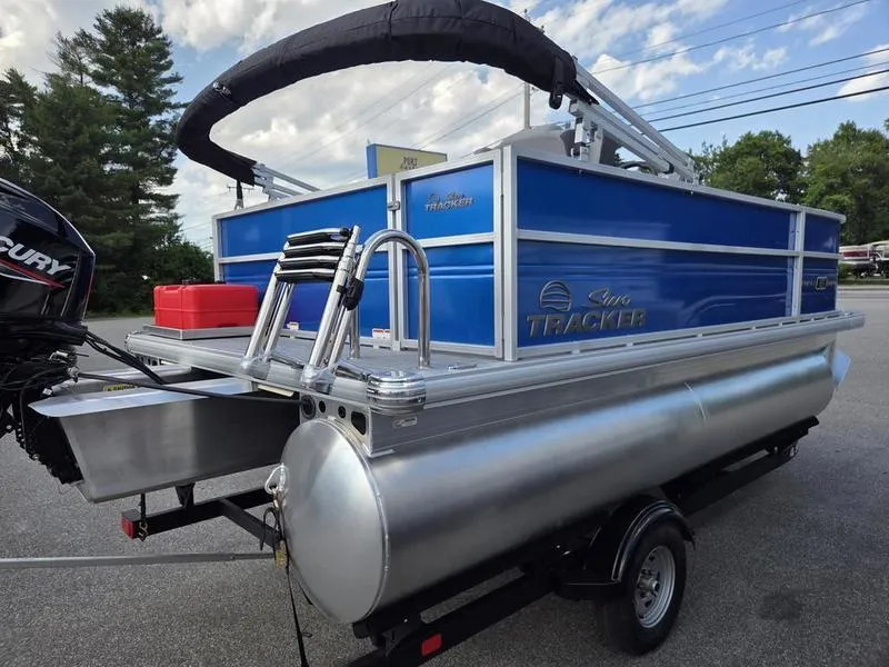 Slide: The Image of 2026 Sun Tracker PB 16 DLX pontoon boat with blue panels and Mercury outboard motor. - 7