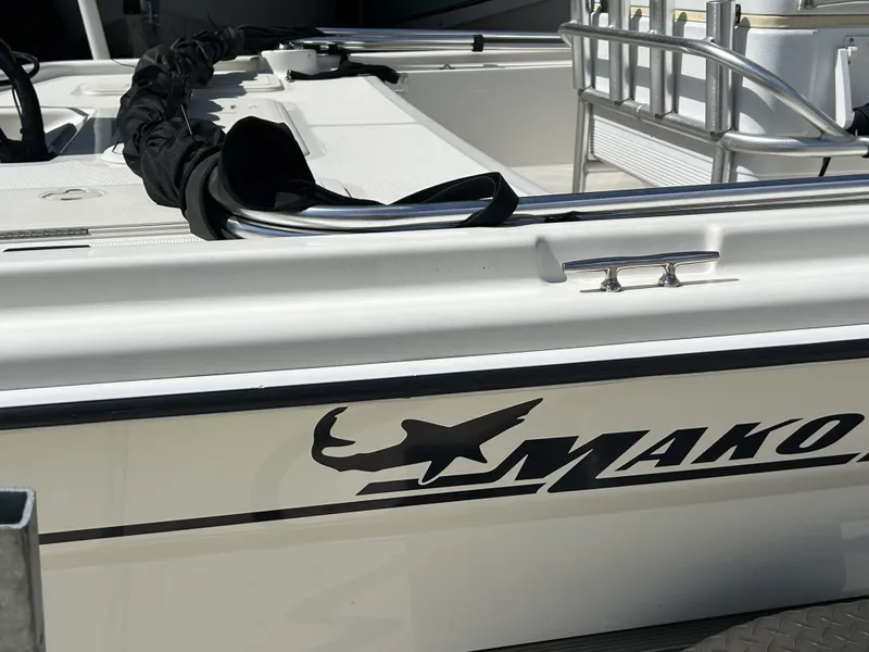 Slide: The Image of 2021 Mako Pro Skiff 19 CC boat, white exterior with logo, docked. - 3