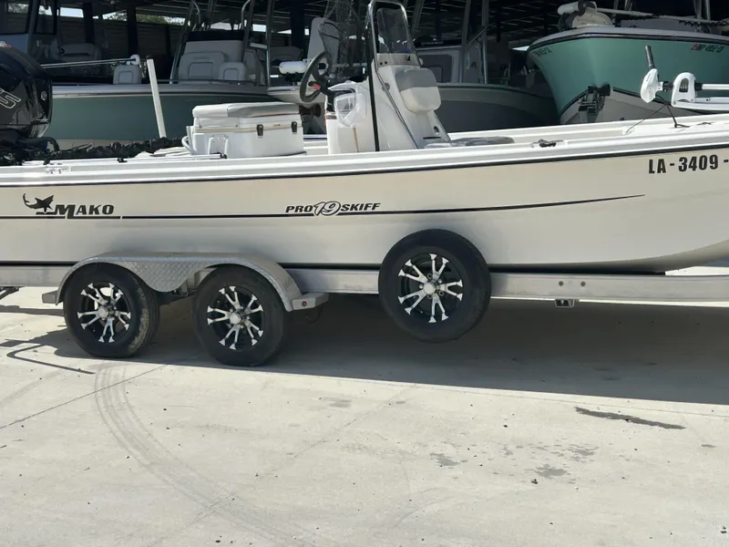Slide: The Image of 2021 Mako Pro Skiff 19 CC boat on trailer in marina setting. - 5