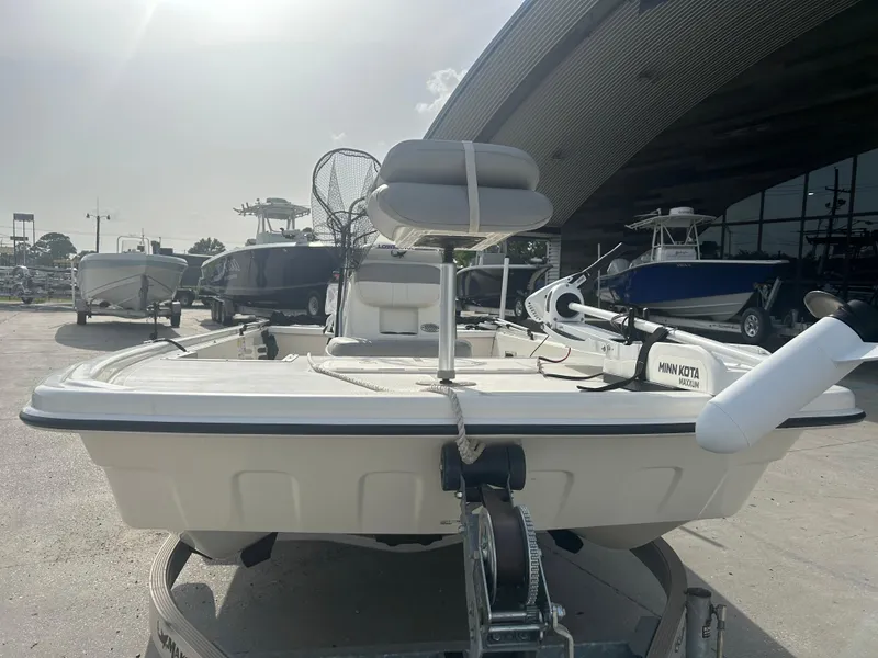 Slide: The Image of 2021 Mako Pro Skiff 19 CC boat on trailer, equipped with Minn Kota trolling motor. - 7
