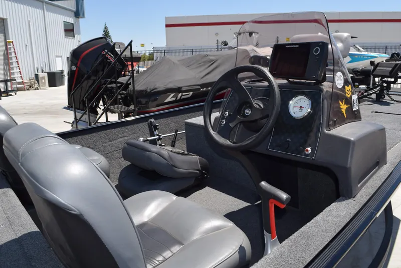 Slide: The Image of 2020 Tracker Bass Tracker Classic XL boat interior with steering wheel and dashboard. - 2