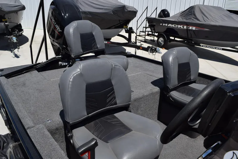 Slide: The Image of 2020 Tracker Bass Tracker Classic XL boat interior with gray seating and Mercury engine. - 4