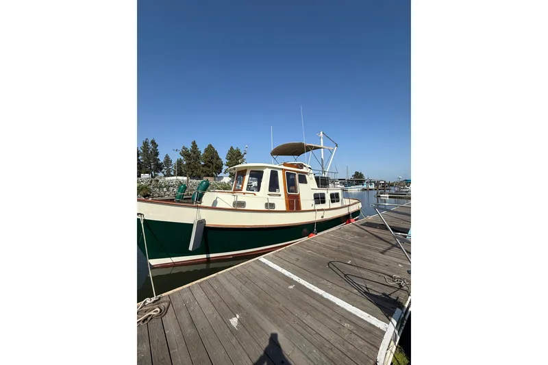 The Image of 1985 Ankertrawler Trawler docked at marina under clear blue sky. - 0