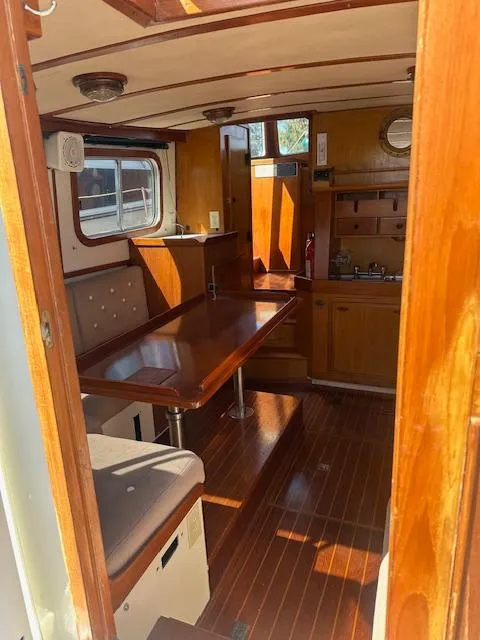 Slide: The Image of Interior of 1985 Eagle Trawler with wooden furnishings and dining area. - 12
