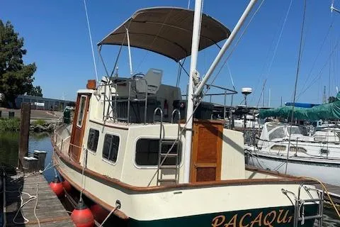 Slide: The Image of 1985 Eagle Trawler docked, featuring a canopy and classic design. - 15